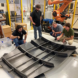 Researchers survey structural component of an aircraft