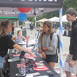 A student talks to other students about voter registration on Greene Street. 