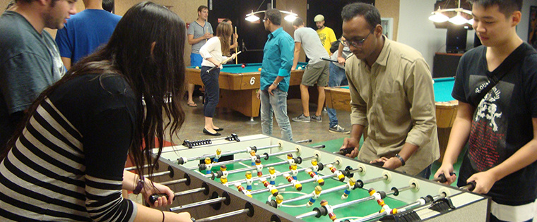 Students enjoying a lively game of foosball in the Golden Spur Game Room.