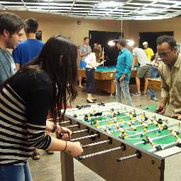 Students playing foosball and pool.