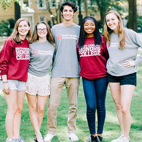 Honors college students standing together on the Horseshoe wearing Honors College apparel including hats, shirts and sweatshirts.