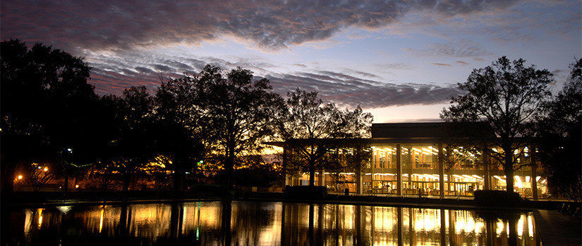 Exterior view of Thomas Cooper Library and fountain during beautiful sunset