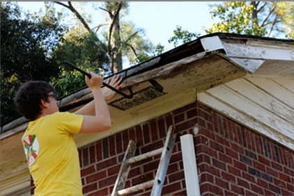 Volunteer repairs a roof during the Service Saturdays, part of 502,334 hours of service in 2013