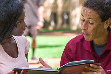 African-American student getting guidance from her professor.
