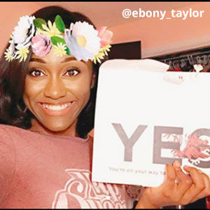 Filtered image provided by @ebony_taylor of a young woman with a flower crown. She is smiling and holding an acceptance envelope that says, Yes!