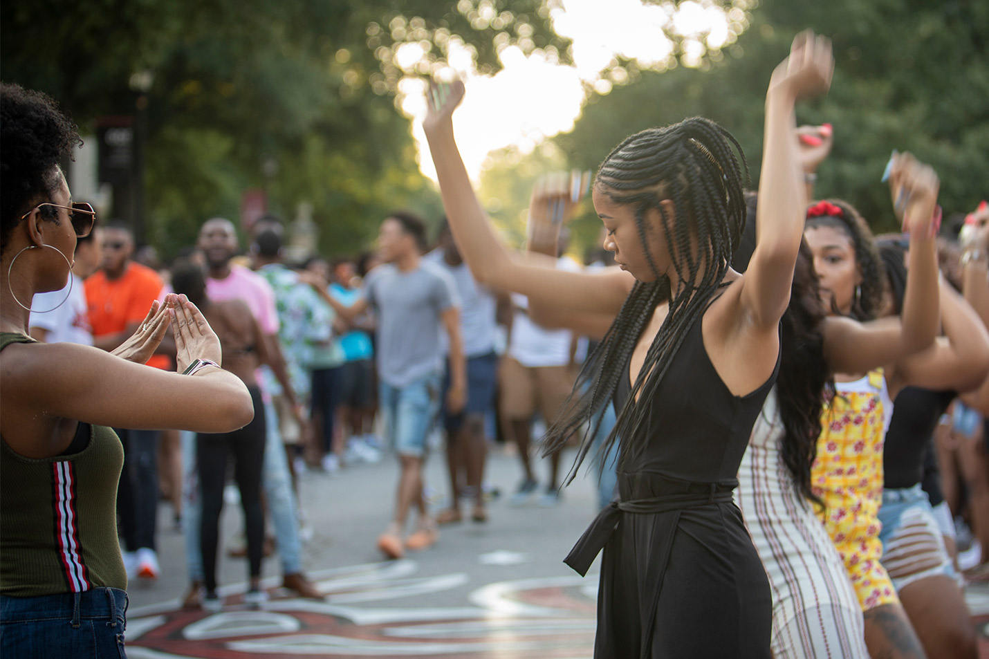Females students dancing on Greene Street