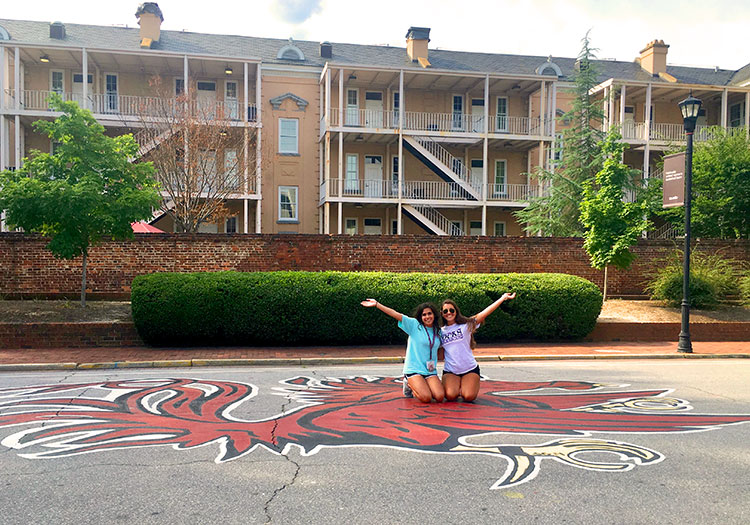 Two students posing in front of Russell House