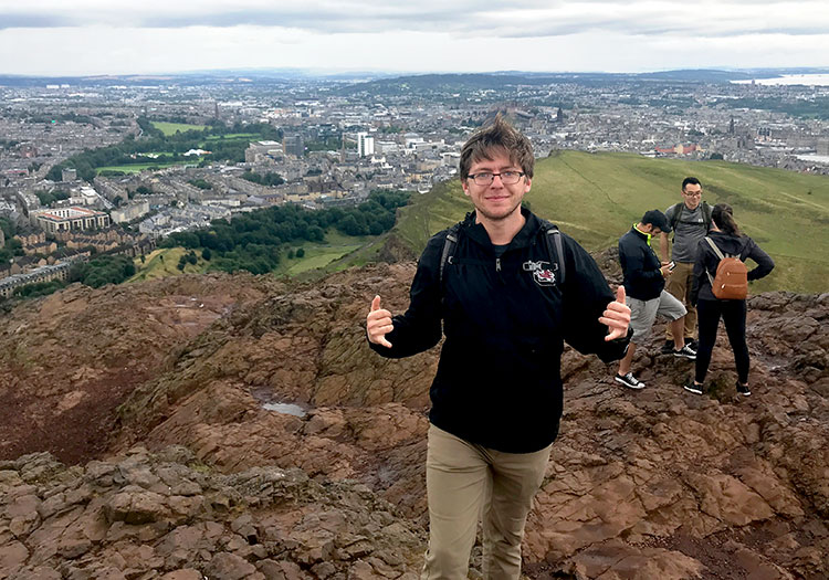 Chase Cunningham standing on top of extinct volcano in Edinburg, Scotland