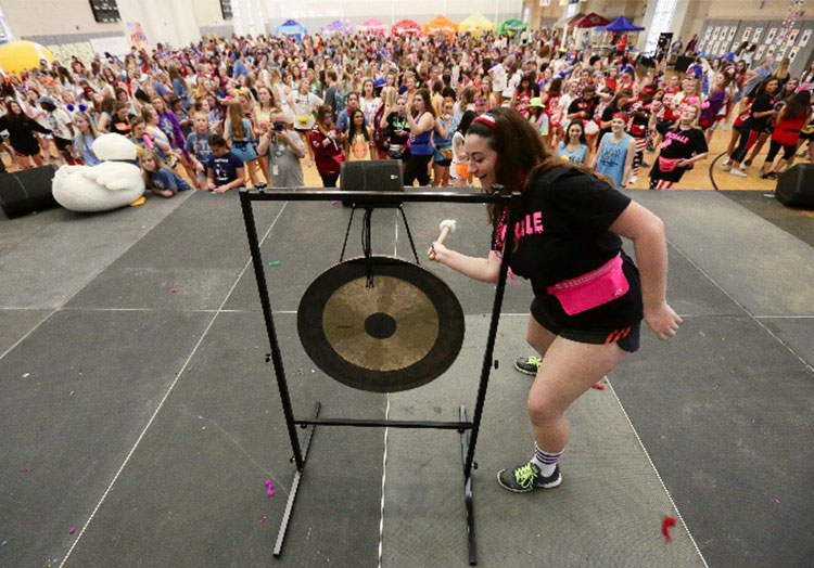 Hannah Garfein banging gong at UofSC Dance Marathon fundraiser