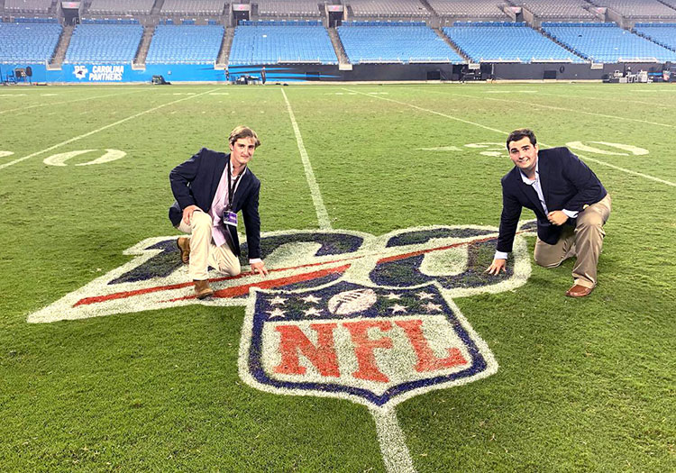 Two journalism students on NFL football field