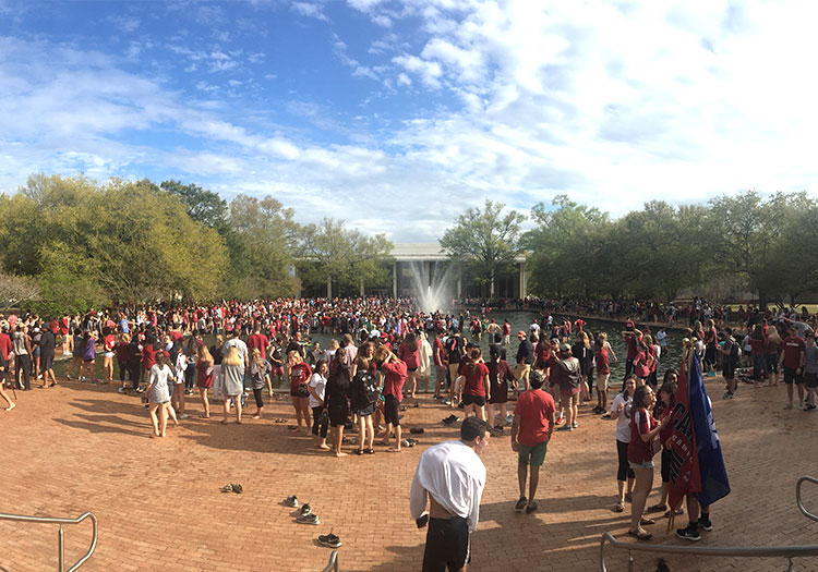 Students celebrating in and near Thomas Cooper Library reflecting pool.