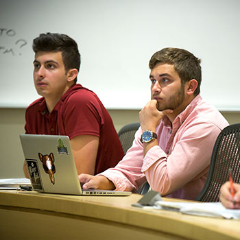 Graduate students in a class listening to the lecturer. 
