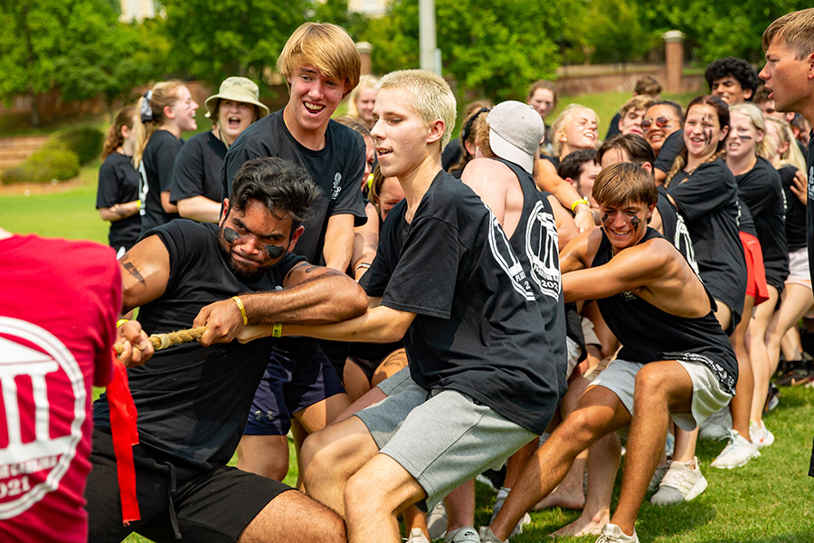 Students pulling on a rope in an intense game of tug-o-war.