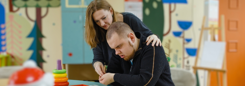 Woman working with a man on a craft project 