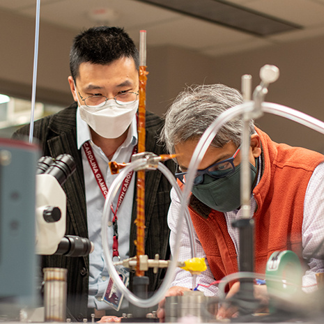 Dr. Farouk and Dr. Yuan work in the lab