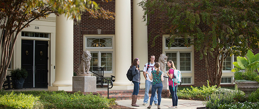 Students congregate outside of academic building 
