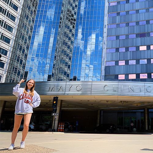 Emily Ariail standing in front of the Mayo Clinic building.