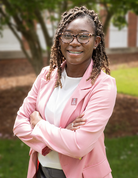 Headshot of Takia Woods outdoors.