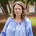 Headshot of Valerie Austin outdoors in a blue shirt. 