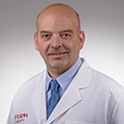 Headshot of Dr. Mark Friedman in a white lab coat.