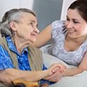 Image of and elderly woman and a younger woman together smiling.