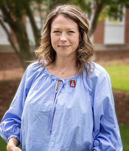 Headshot of Valerie Austin wearing a blue shirt outdoors. 