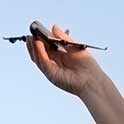 hand holding model airplane 