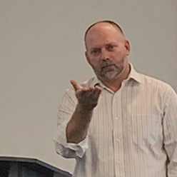 Matt Irwin, Ph.D. making a presentation at a podium