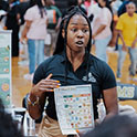 woman in a gym holding informational flyer