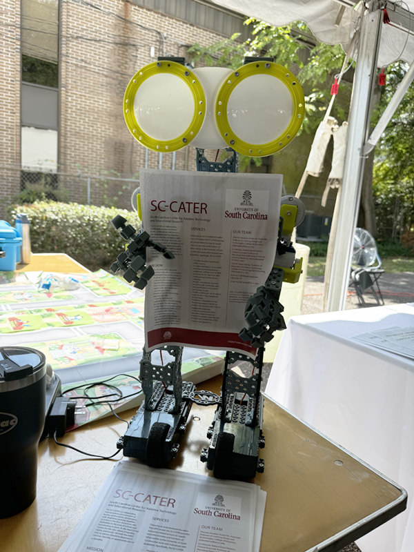 Robot holding a flyer for SC-Cater