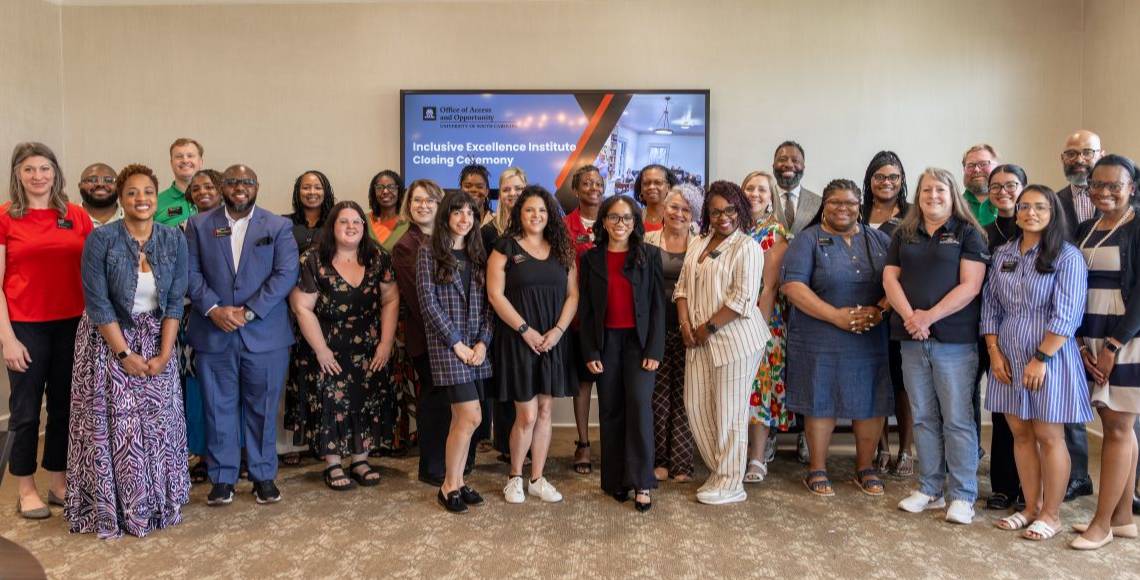 Banner image of the inclusive excellence institute cohort group smiling together