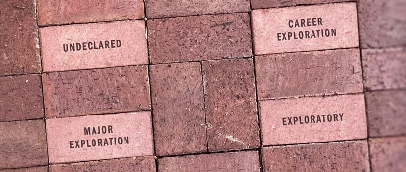 A series of bricks from the USC Horseshow are pictured with phrases etched on them. Phrases include exploratory, major exploration, undeclared, and career exploration. 