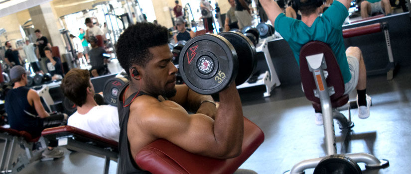 Student lifts weights inside the Strom Thurmond Wellness & Fitness Center