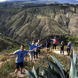 Students standing in vegetation on a mountain