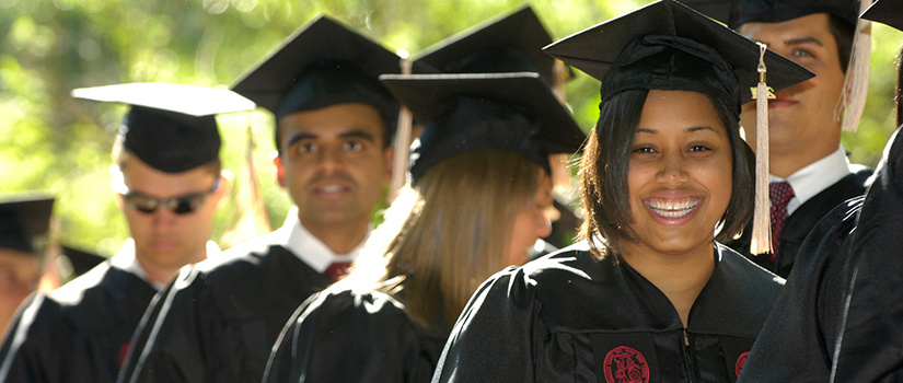 student at graduation with robe and hat on