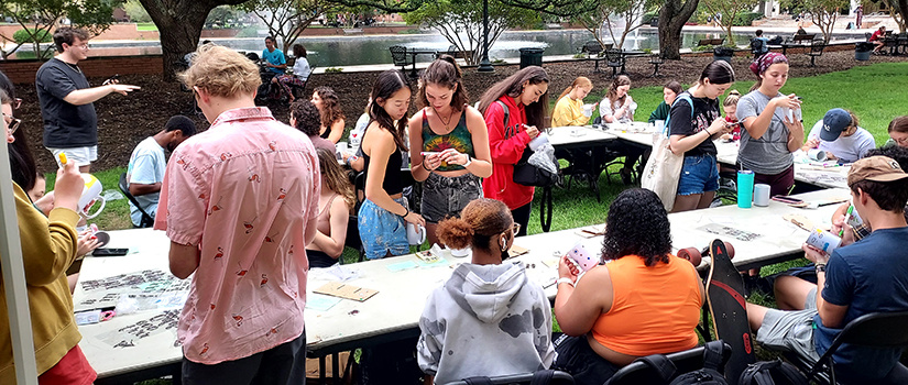 students gathering information at an outside fair