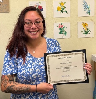 woman standing holding certificate