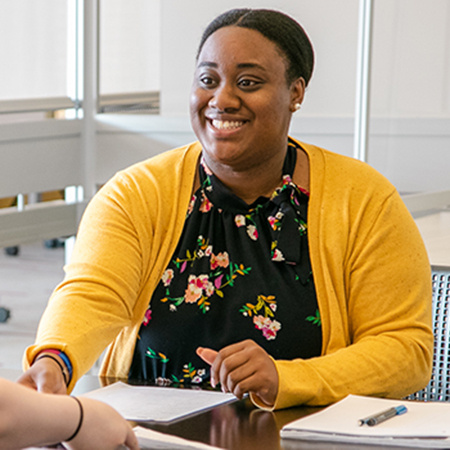 a student and staff member working together