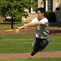 a male student playing frisbee on the horseshoe