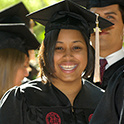 student at graduation with robe and hat on