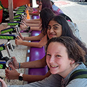 students playing a shooting carnival game