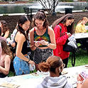 students outside at an event getting information