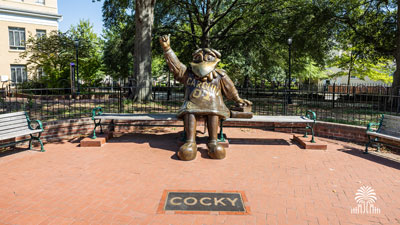 The Cocky Statue as seen from directly in front with tree and gates mark.