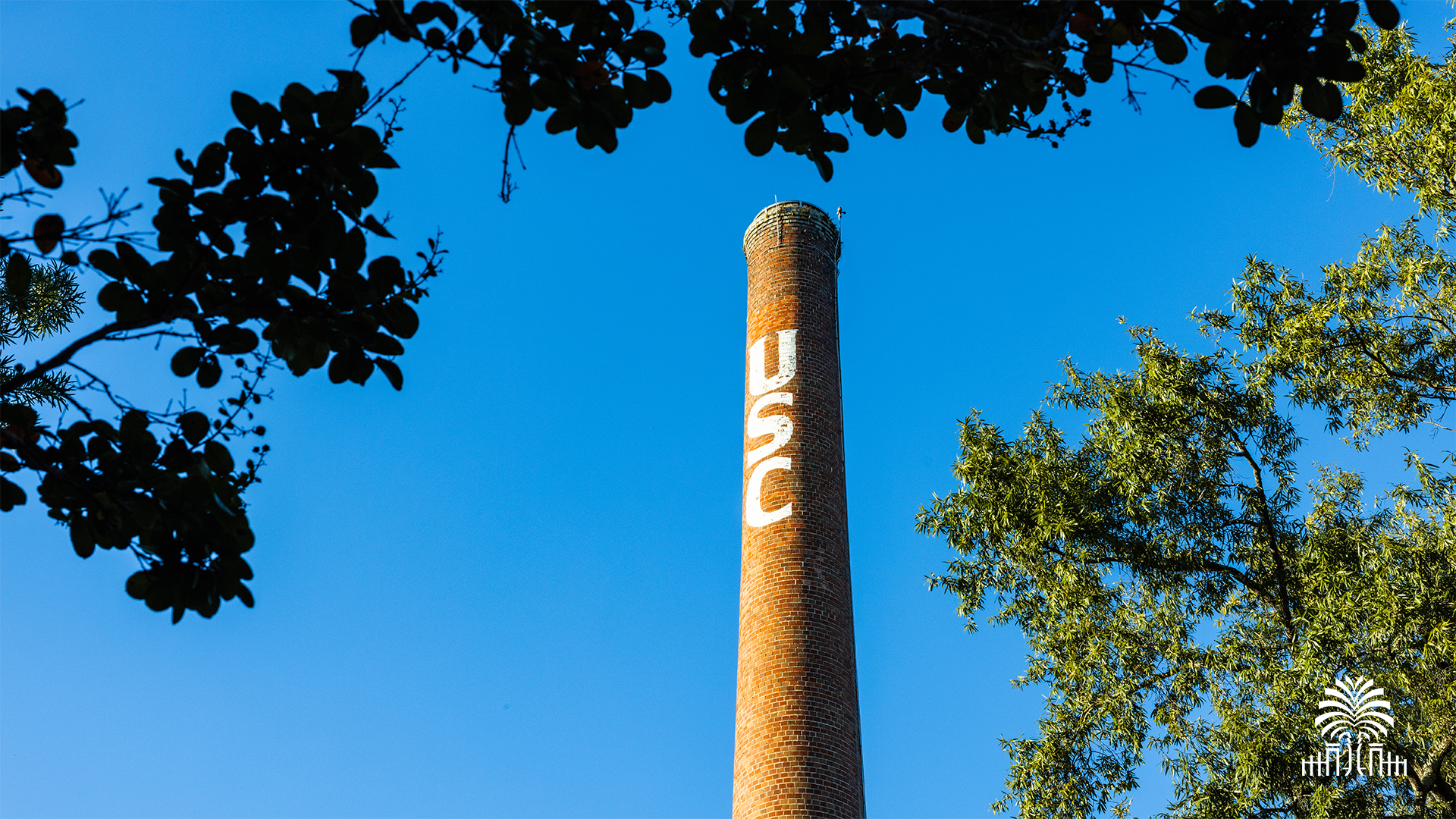 The USC smokestack with tree and gates mark
