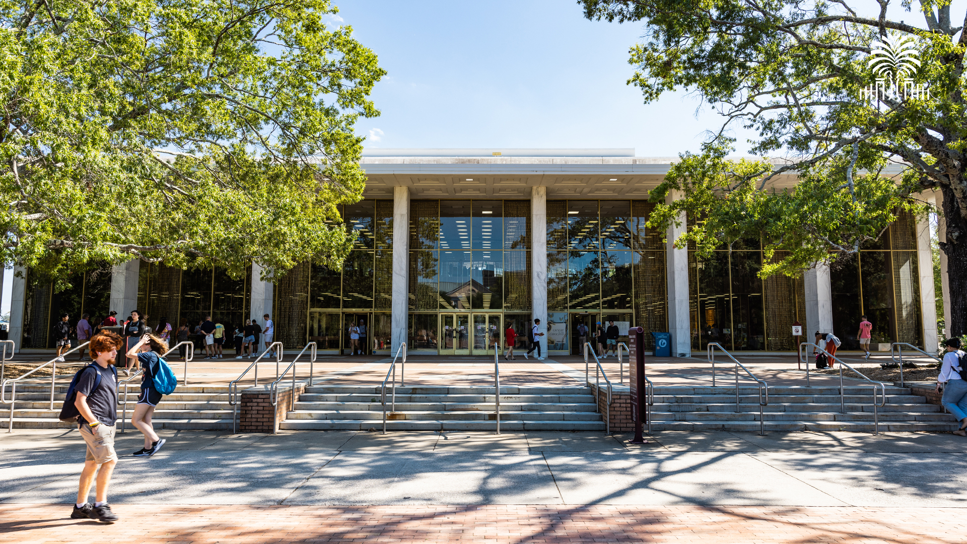 The front entrance of Thomas Cooper Library with tree and gates mark