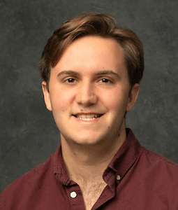 man in garnet shirt smiling