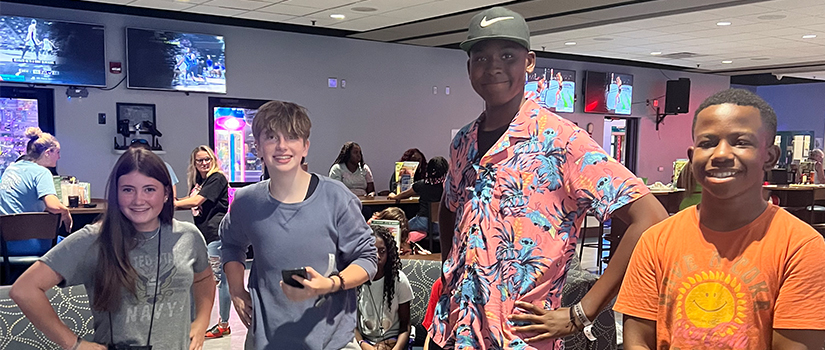 four students at the bowling alley