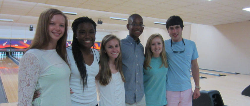 six Carolina Master Scholars standing in front of the bowling lanes