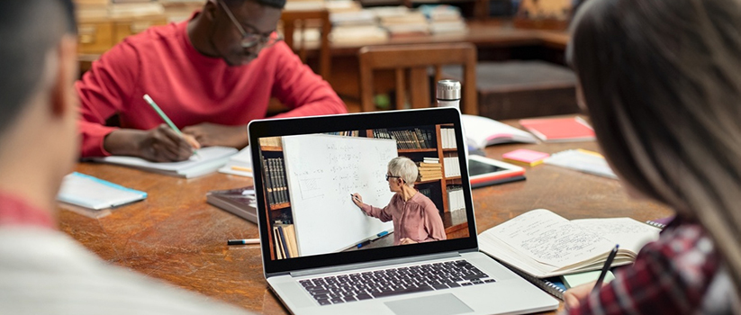 Students watching online course on laptop