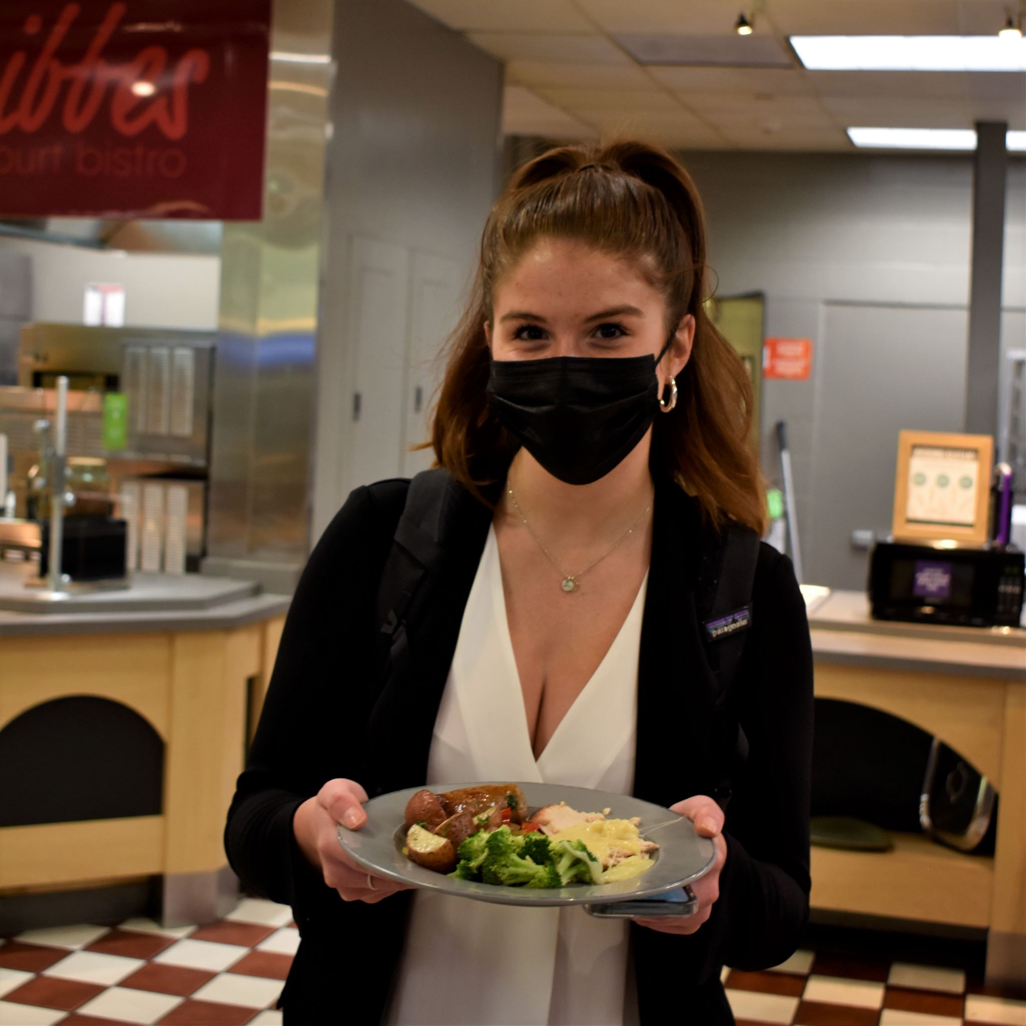 Student with plate in dining hall